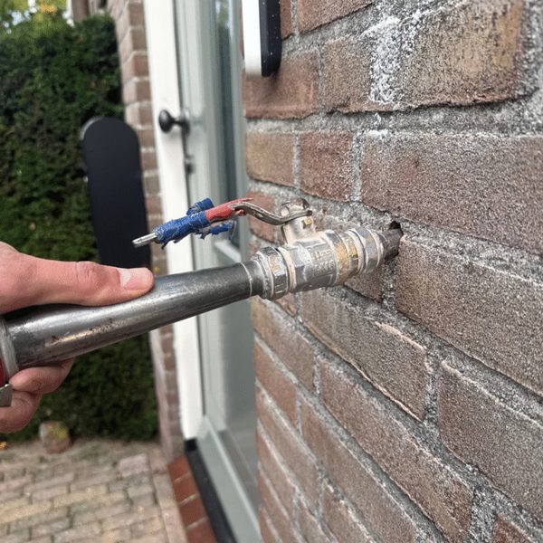 Cavity wall insulation: insulation material being blown into the cavity